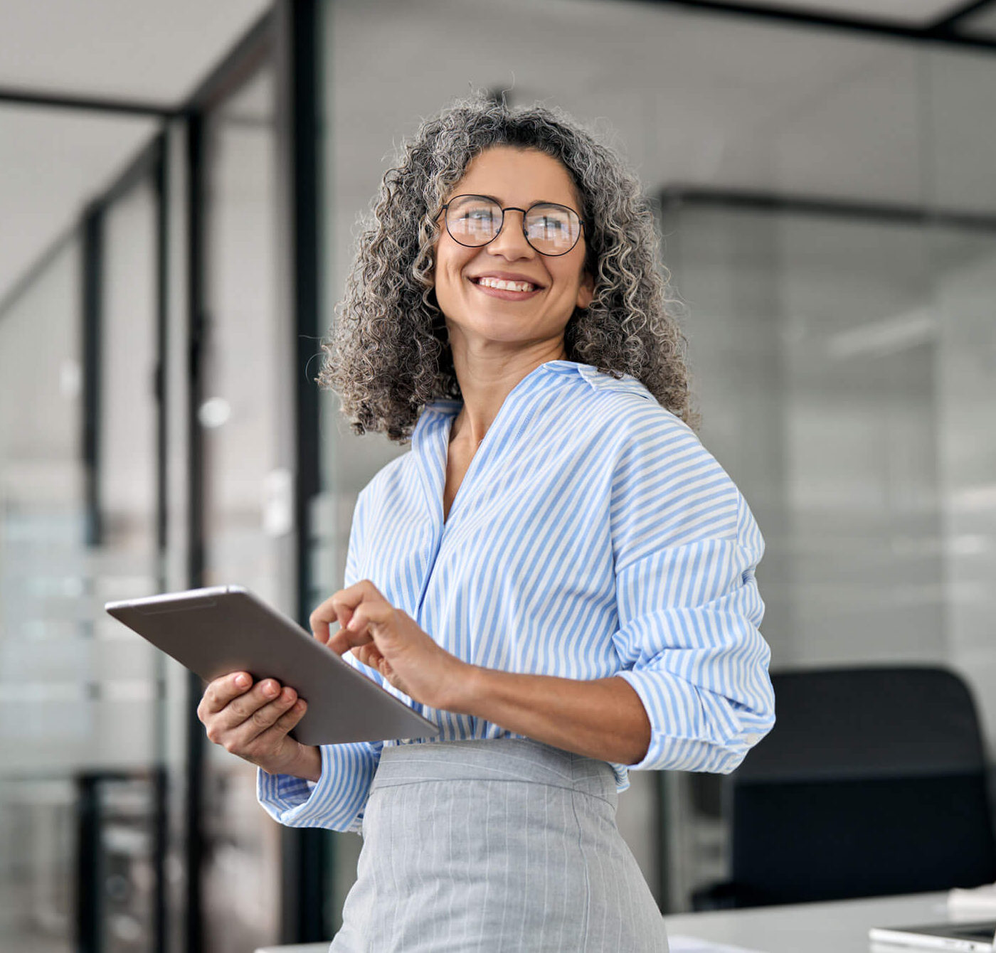 employer holding iPad and smiling